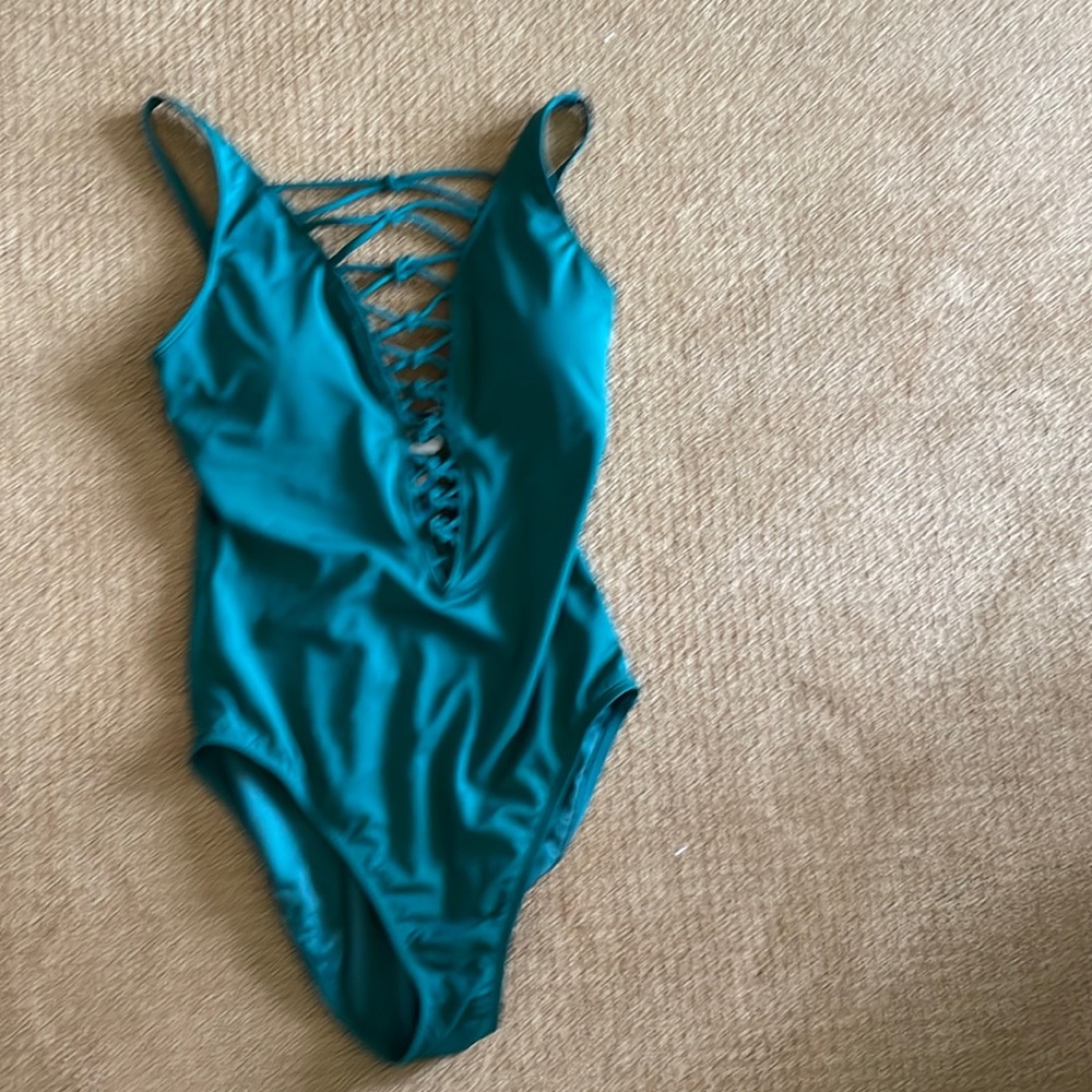 NWT green one piece with flattering cut outs.